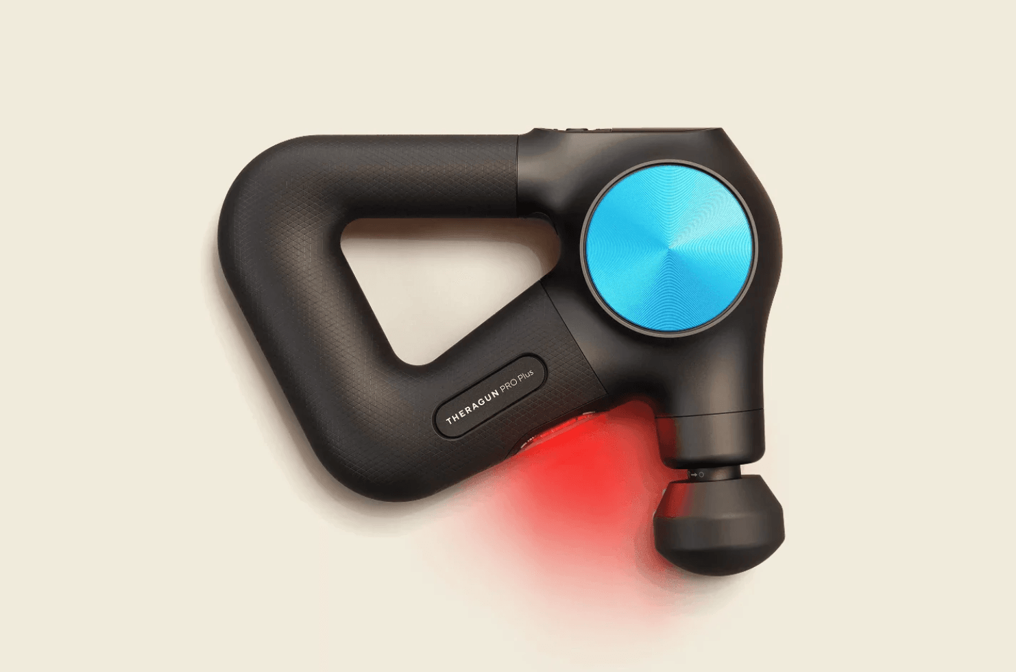 Een zwarte Theragun PRO Plus massagepistool met een blauw motorkap en rood LED-licht dat de warmte- en lichttherapie functie toont.